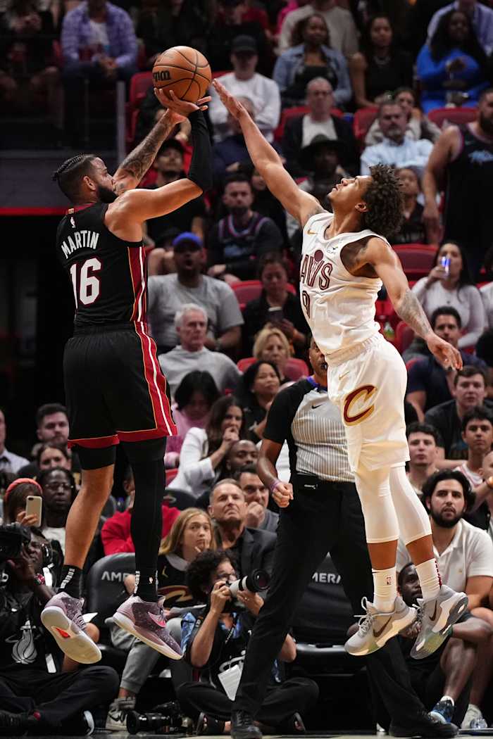 Dec 8, 2023; Miami, Florida, USA; Miami Heat forward Caleb Martin (16) shoots over Cleveland Cavaliers guard Craig Porter (9) during the second half at Kaseya Center.